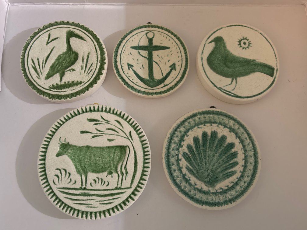 5 plaster casts of antique butter molds; painted, w/ hanger