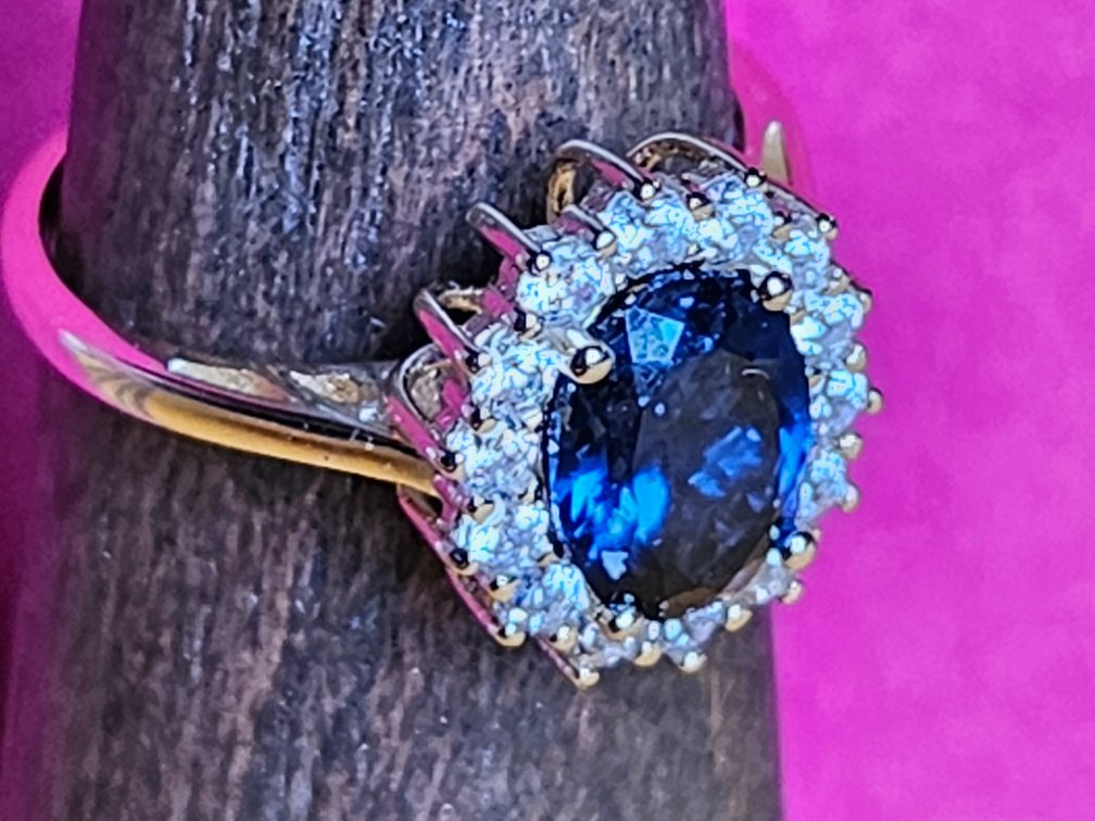 Gold Vermeil Ring with Diamond-like Stones Surrounding a Sapphire Style Stone