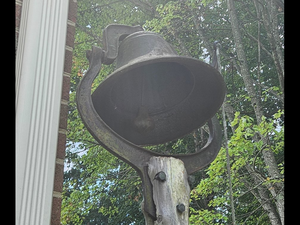 Antique Farm Bell on old cedar post