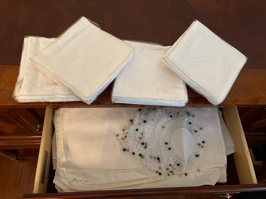 Contents of drawer and middle doors in dining room sideboard: table linens