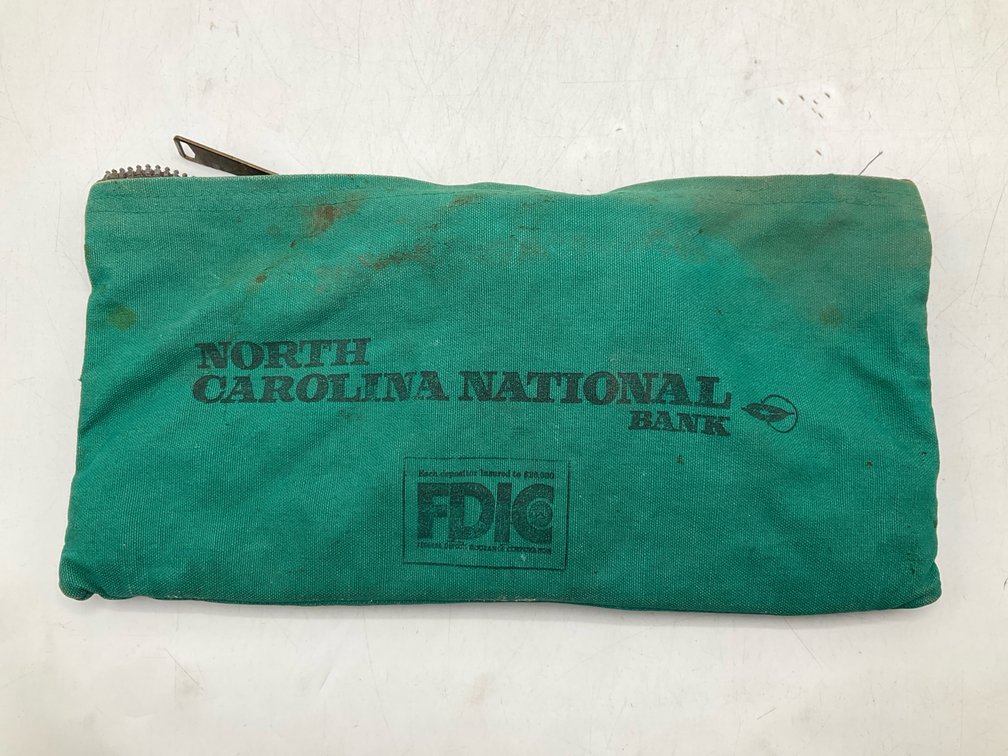 Assorted Pennies in a Green Canvas Bank Pouch