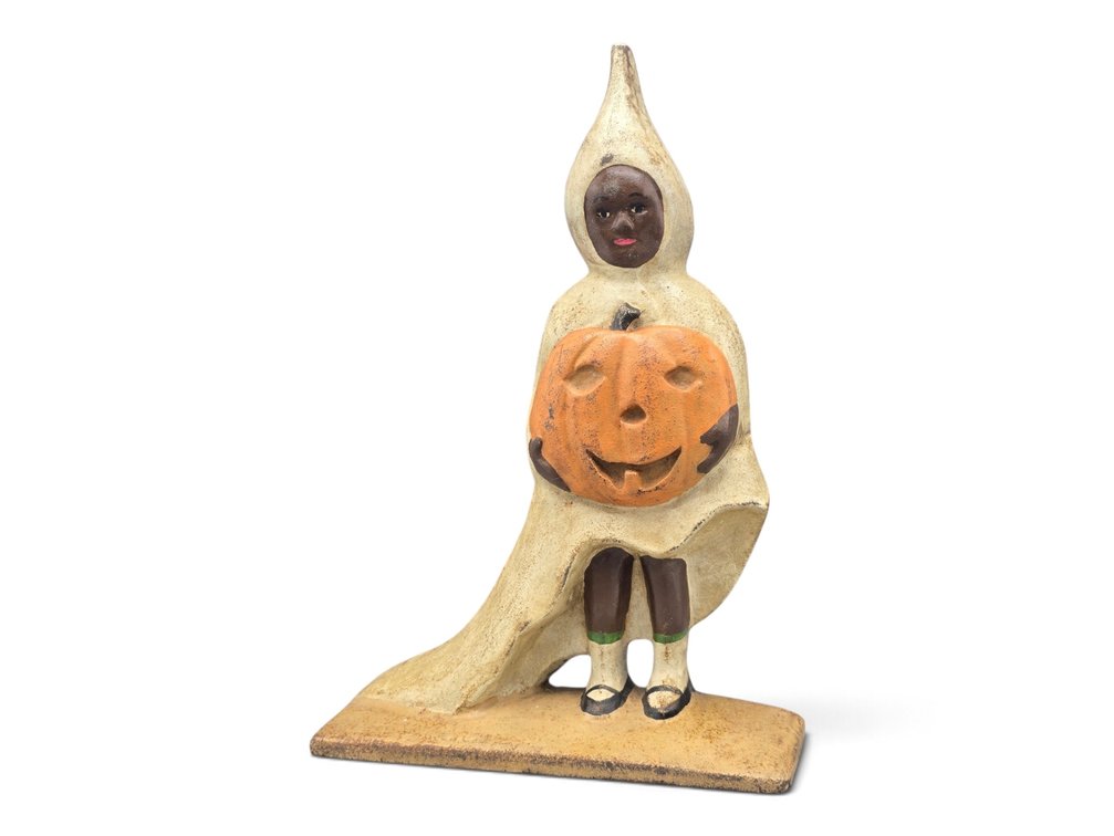 Cast Iron Figural Doorstop as a Girl with Jack-o-Lantern