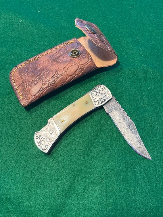 Handcrafted folding Damascus knife with sheath