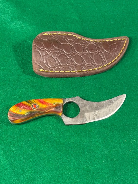 Small handcrafted, Damascus blade knife with finger hole and leather sheath