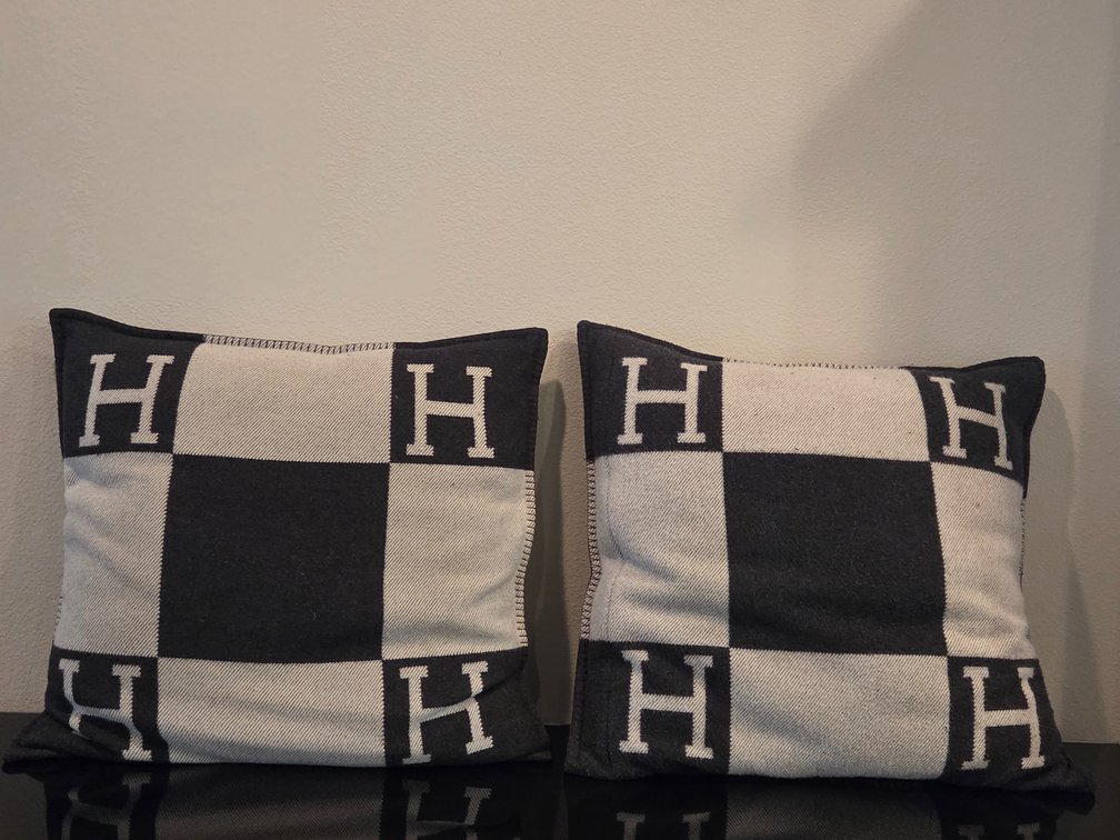 2 large Hermès Avalon throw pillows in a dark grey and ecru wool-cashmere blend.