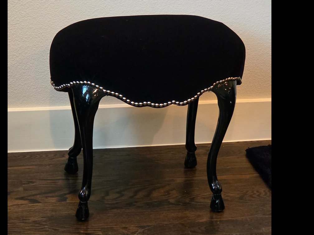 Baroque-style black velvet footstool with glossy cabriole legs and silver nailhead trim