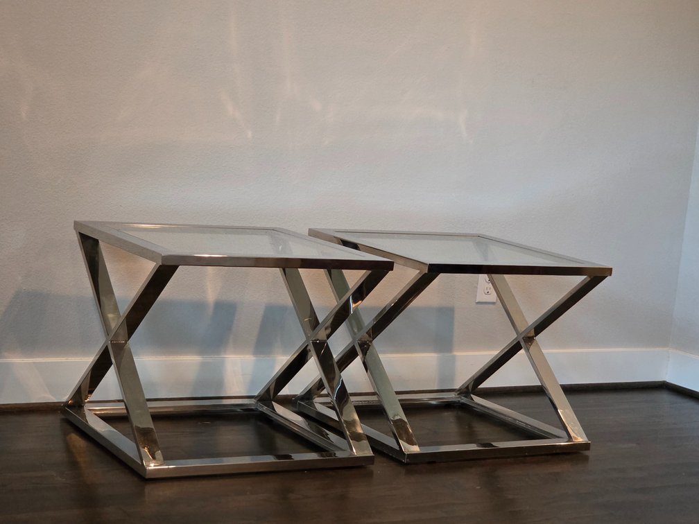 2 modern square end tables with clear glass tops and polished metal crisscross bases