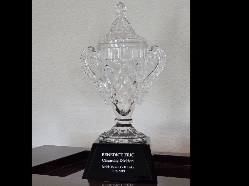 Ornate cut-crystal golf trophy cup with a lid mounted on a black pedestal base