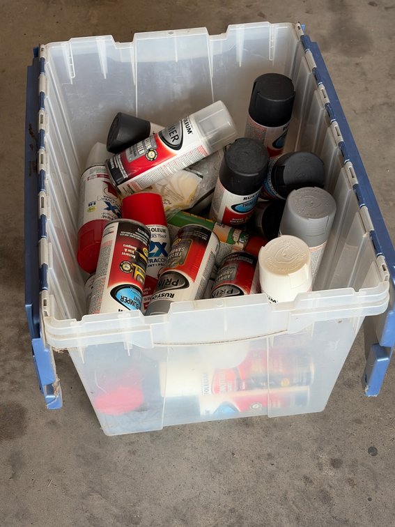 Tub full of spray, paints, and primers