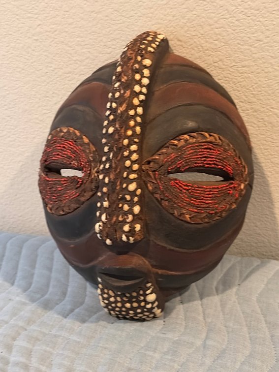 a handcrafted wooden African tribal mask, resembling traditional Central African styles such as those from the Kuba or Baluba peoples of the Democratic Republic of the Congo.