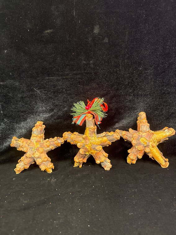 rustic star-shaped Christmas tree or holiday ornaments crafted from natural materials like pinecones