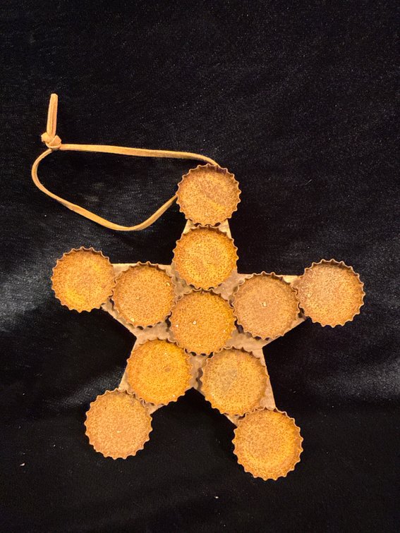handmade Christmas star ornament crafted from recycled soda bottle caps