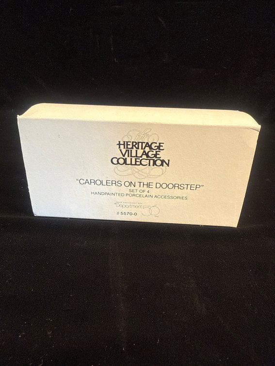 Department 56 Heritage Village Collection set titled "Carolers on the Doorstep" (Item #5570-0)