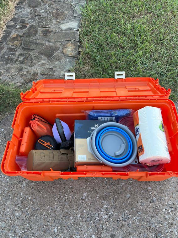 Camping gear in Orange Plano, trunk, cookware, and more for camping