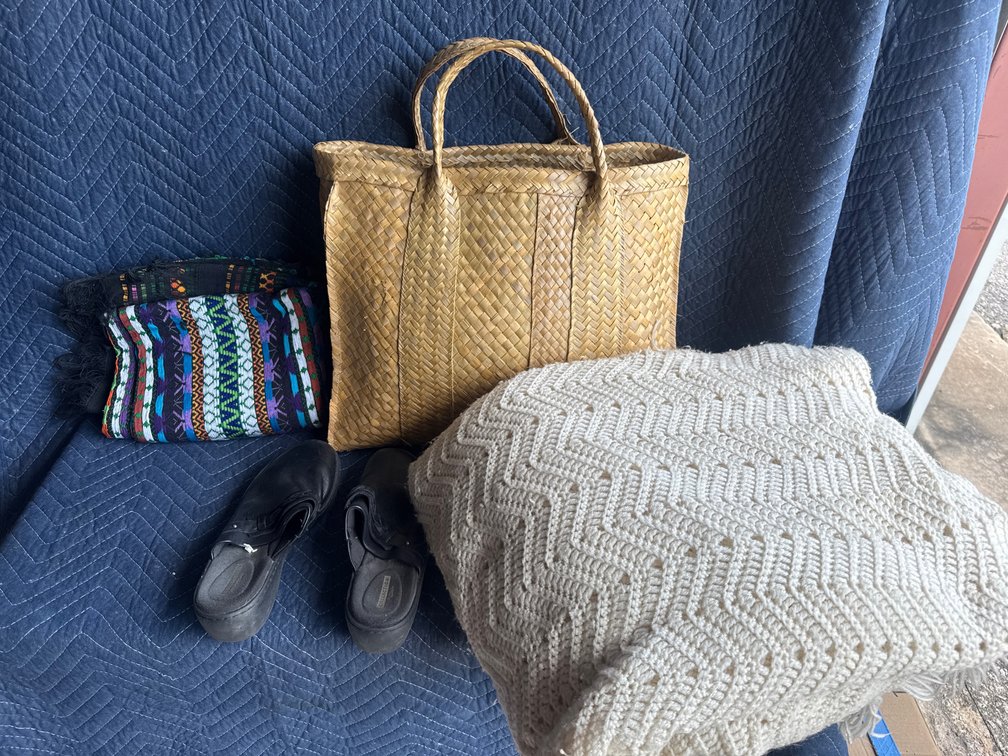 handwoven straw or grass market tote bag with dual braided top handles With two blankets and a pair of size 7.5 Clarks shoes