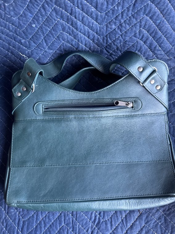 purse is Rapp & Posavek (often stylized as Rapp & Posavek Woven). This is a rare designer brand known for creating high-quality, artisanal woven and paneled leather luxury handbags.
