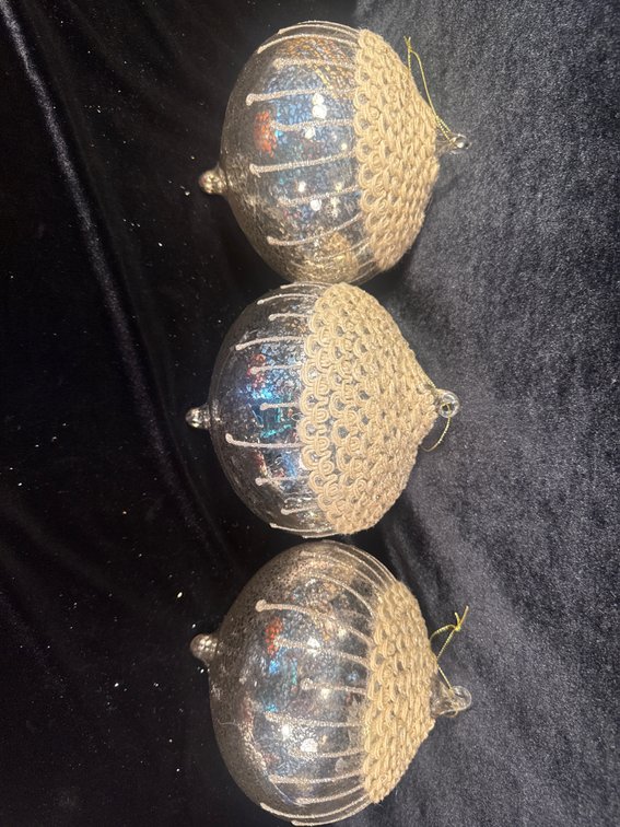 3 large vintage-style blown glass teardrop or onion-shaped Christmas ornaments with an iridescent or mercury glass finish, vertical gold- or white-glitter stripes, and textured detailing