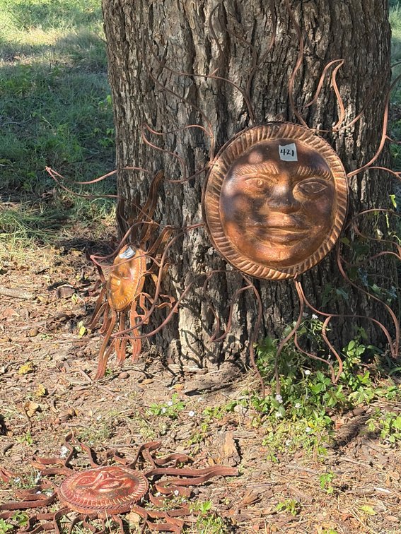 Set a three terra-cotta sun faces with metal frame one large two small