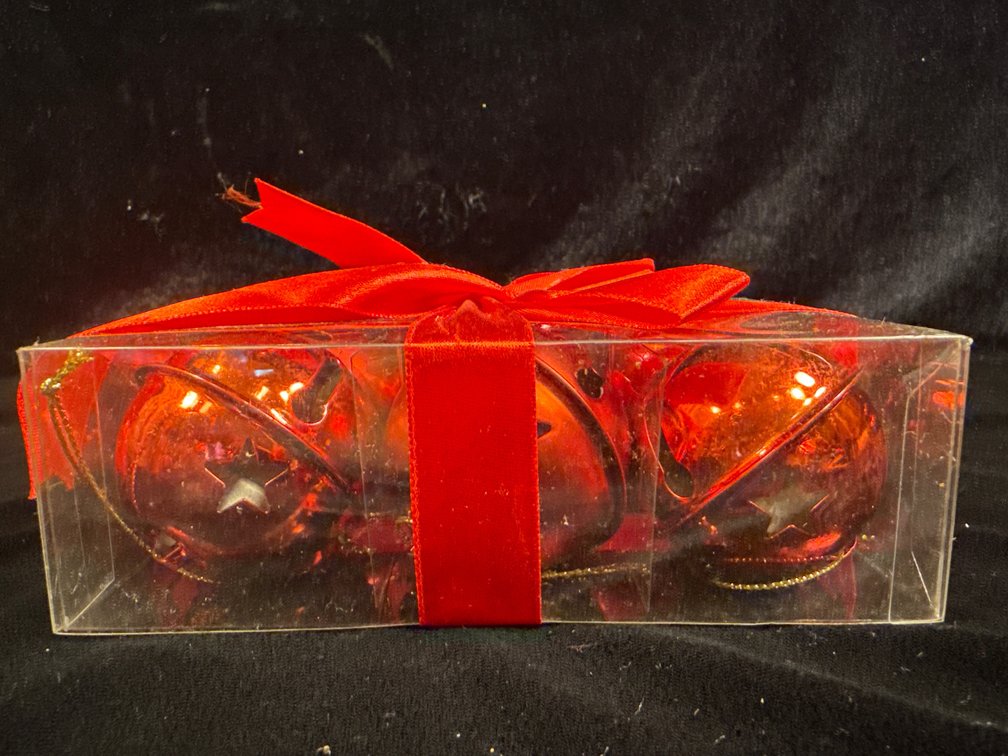 a boxed set of 6 red decorative star-shaped Christmas ornaments