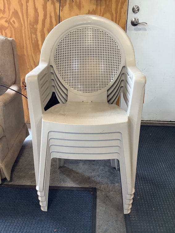 Five plastic stacking chairs