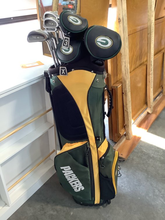 Golf clubs in Green Bay Packer golf bag with Green Bay Packers club covers