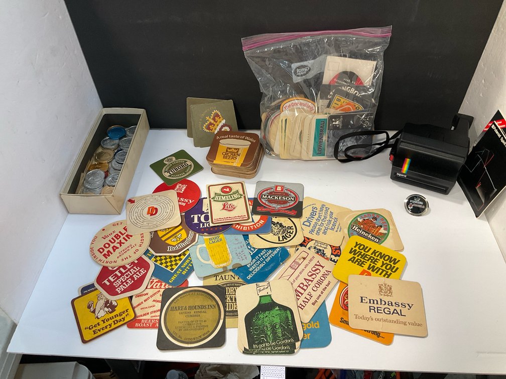 Polaroid camera, tokens, cardboard coasters