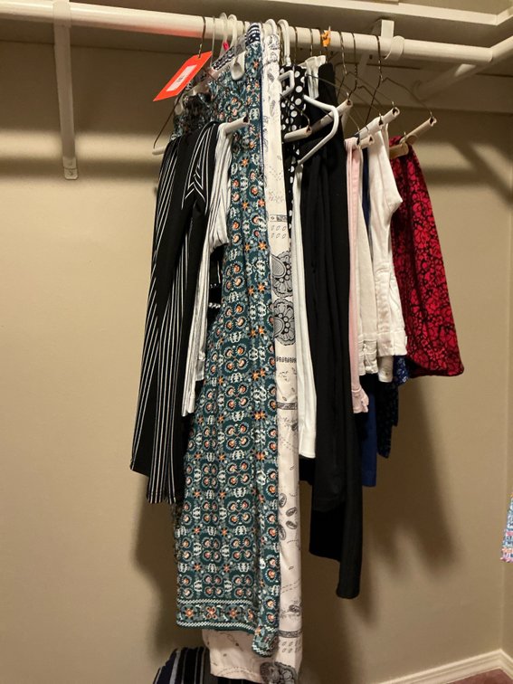 Grouping of ladies pants hanging & on floor-Master bedroom closet