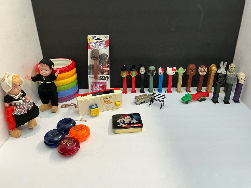 Pez dispensers, Fisher-Price camera, dolls, yo-yos, and assorted