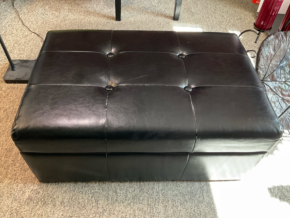 Black tufted faux-leather storage ottoman 32" x 21" x 13"