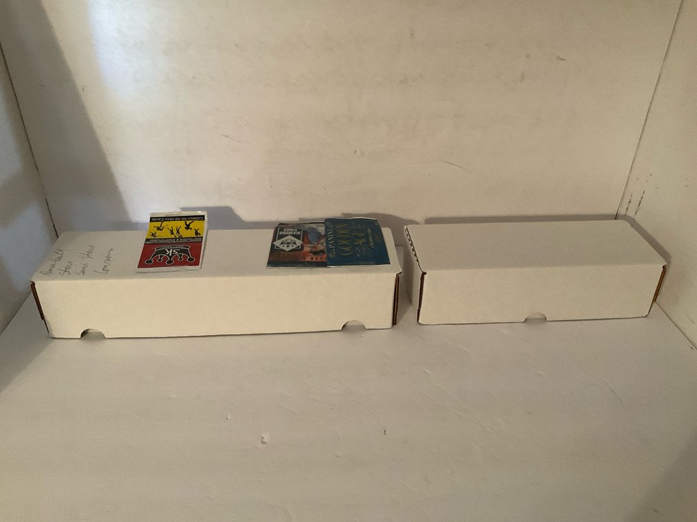 Assorted baseball trading cards in storage boxes