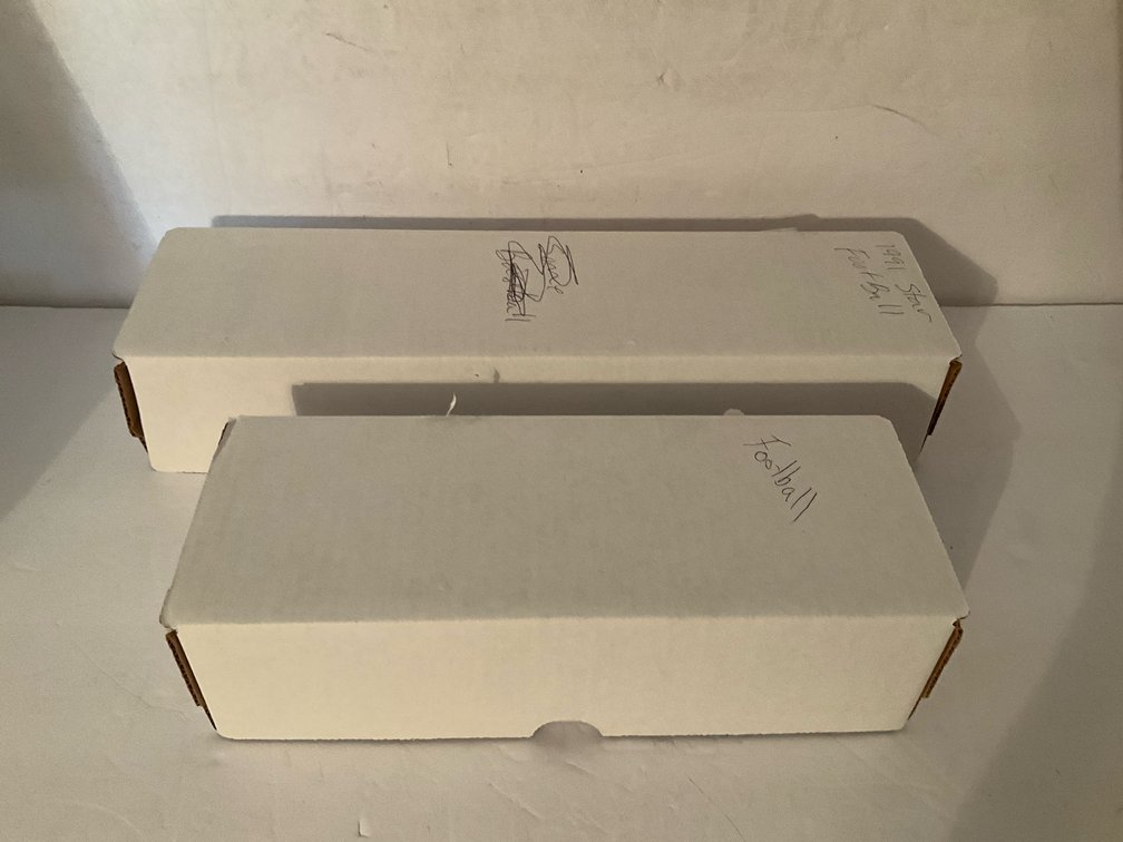 Assorted football trading cards in storage box