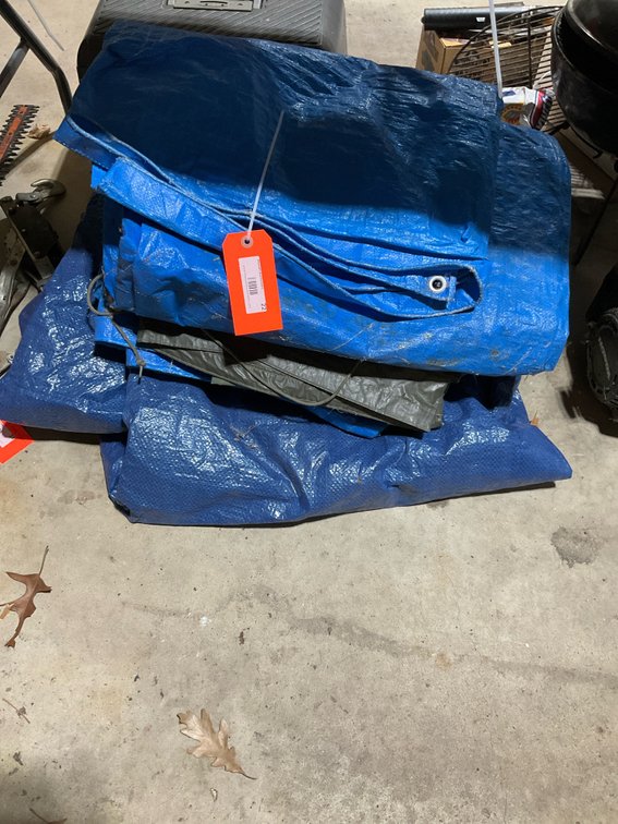 Grouping of folded blue & olive green woven tarps