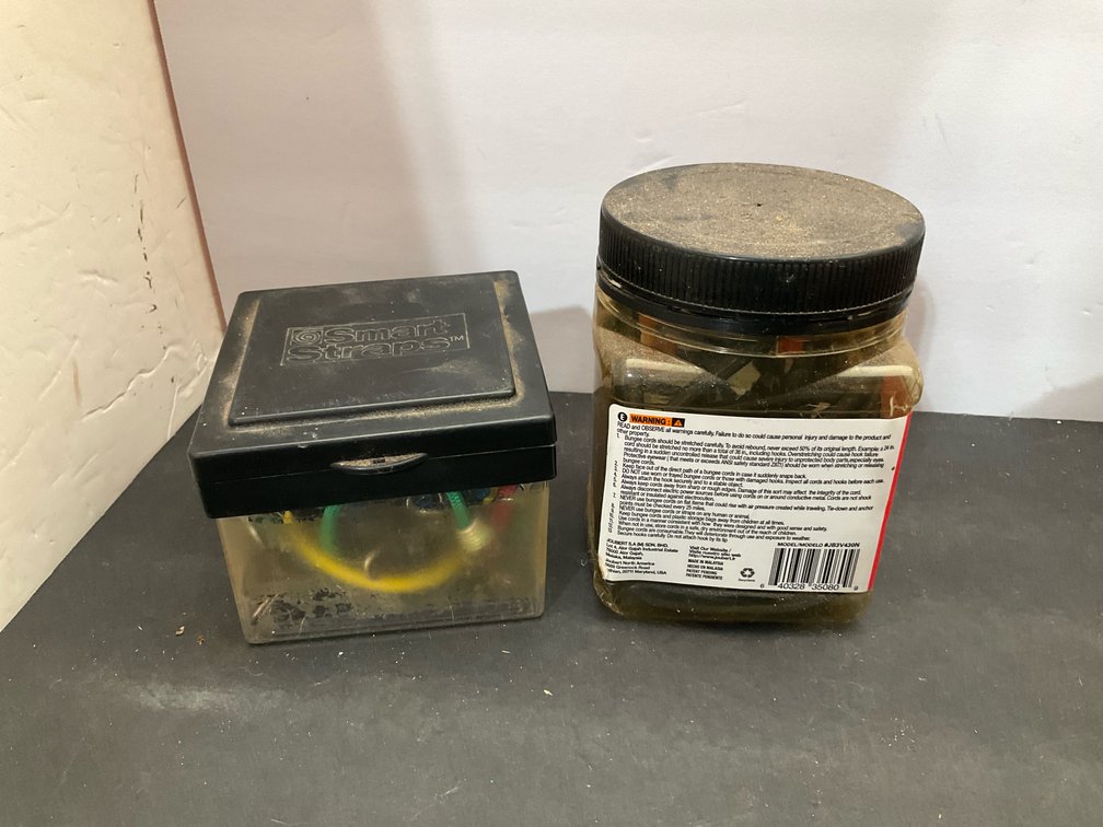2 clear plastic containers of bungee cords