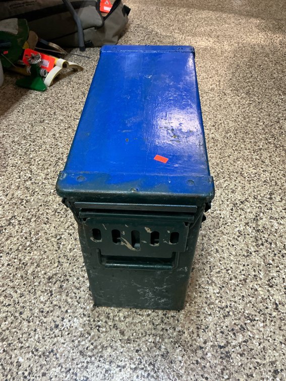 Olive drab metal ammunition can with blue lid