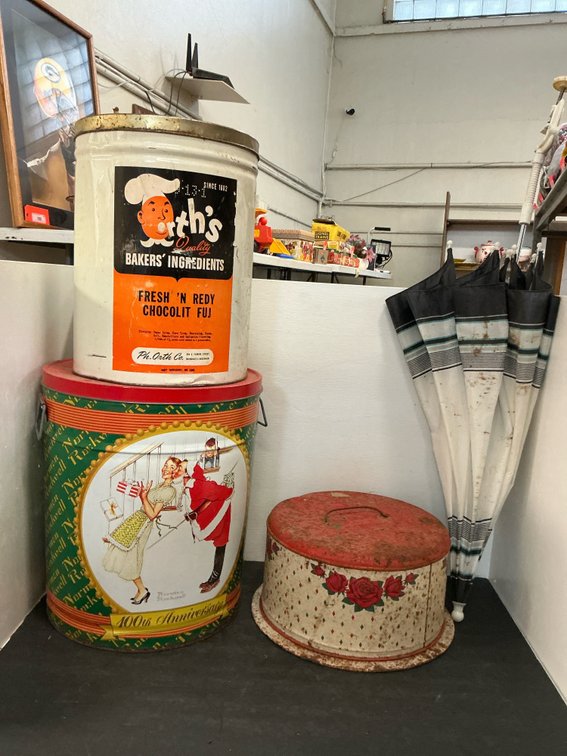 Grouping of metal tins & striped umbrella