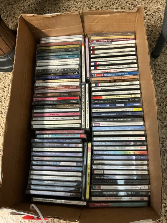 Grouping of assorted music CDs in jewel cases