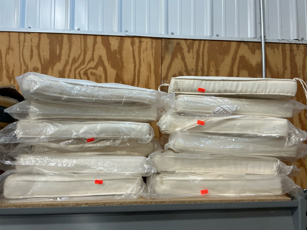 Grouping of off-white seat cushions with ties