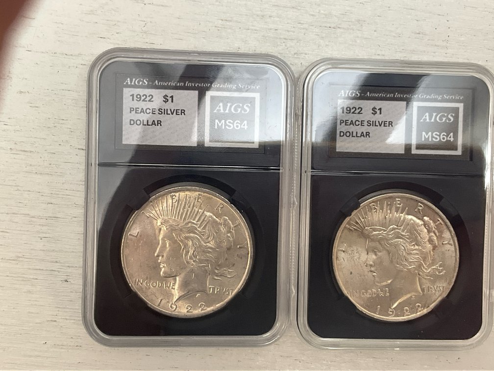 2 1922 Peace silver dollars in grading slabs