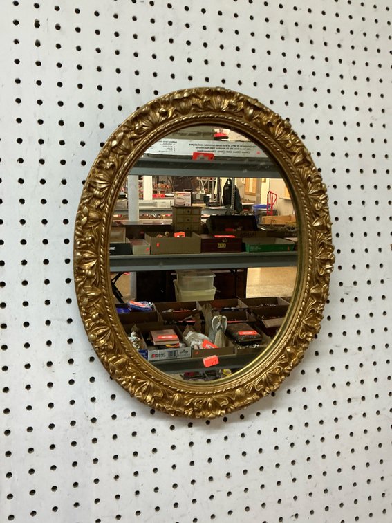 Ornate gold-tone framed oval wall mirror