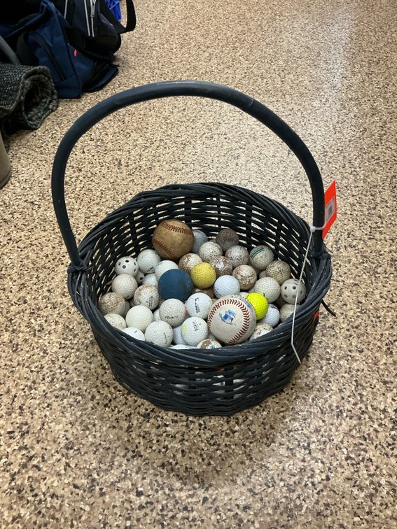 Wicker basket of assorted golf balls & baseballs