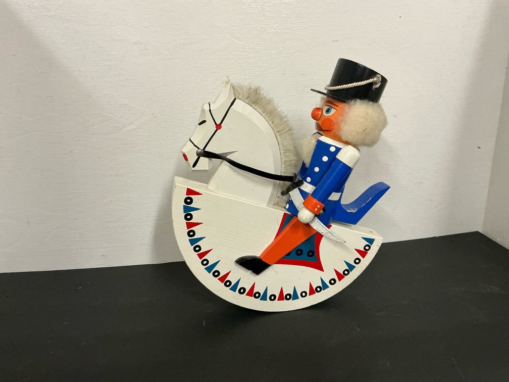 Painted wood nutcracker soldier on rocking horse