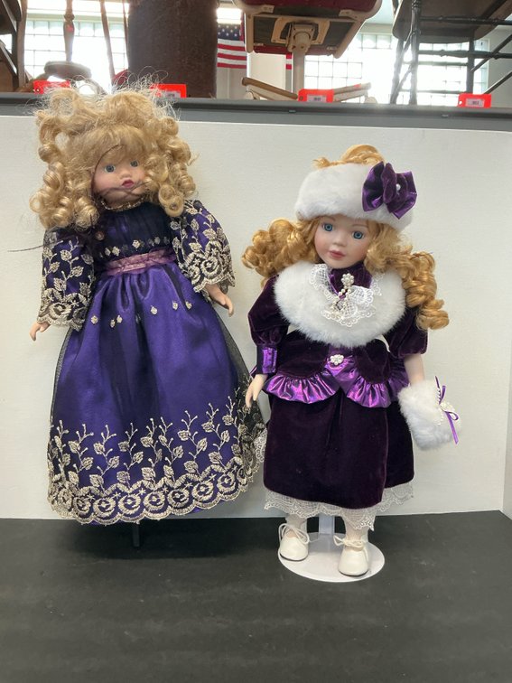 Pair of blonde dolls in purple dresses