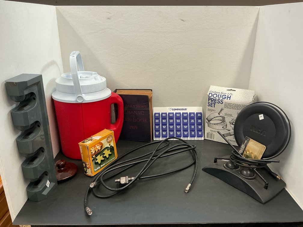 Household grouping with RCA TV antenna, cooler & book