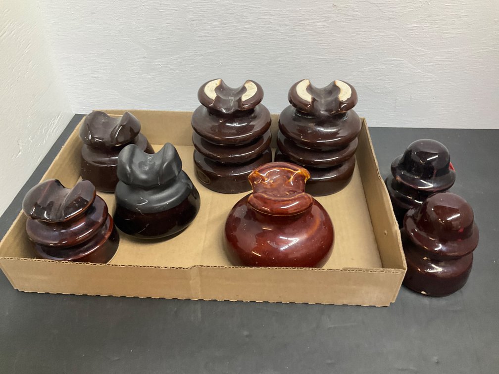 Grouping of brown ceramic pin-type insulators