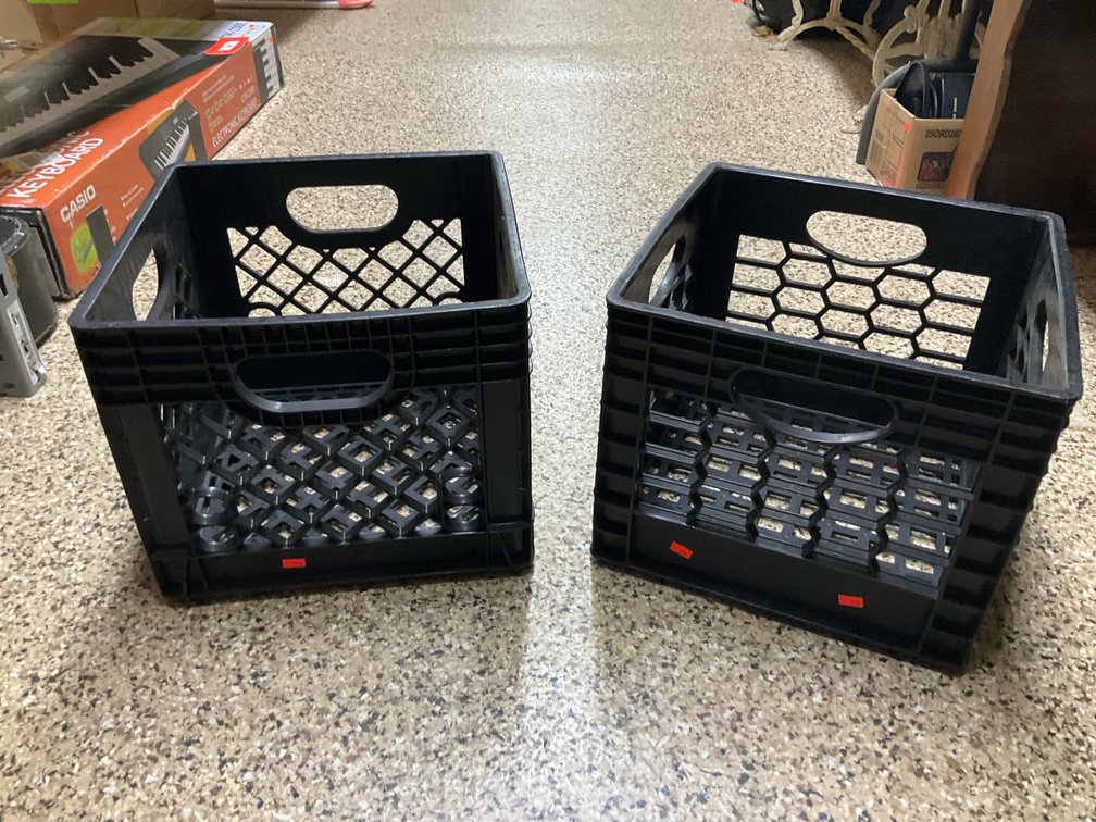 2 black plastic milk crates with side handles