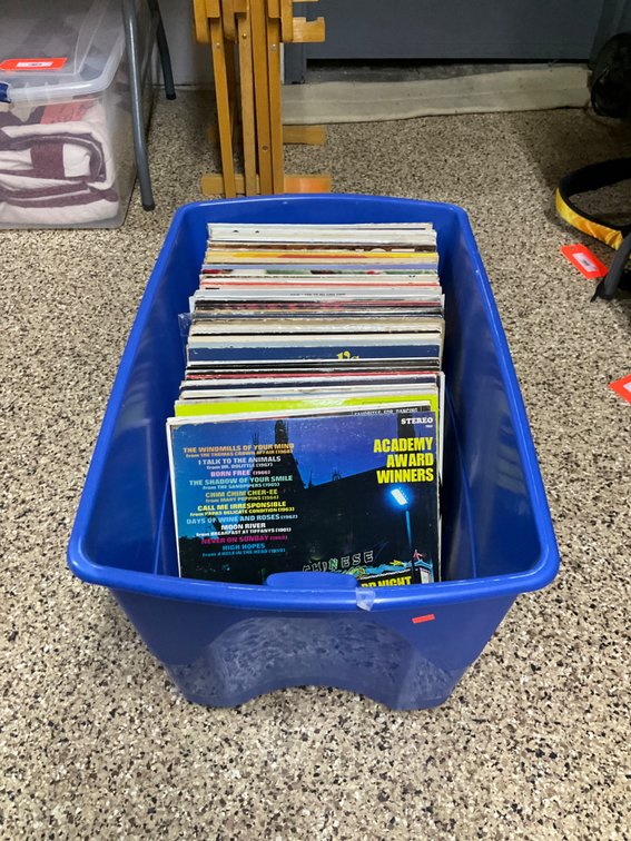 Grouping of vinyl LP records with blue plastic tote