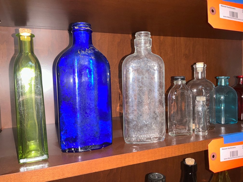 Grouping of assorted glass bottles & vases