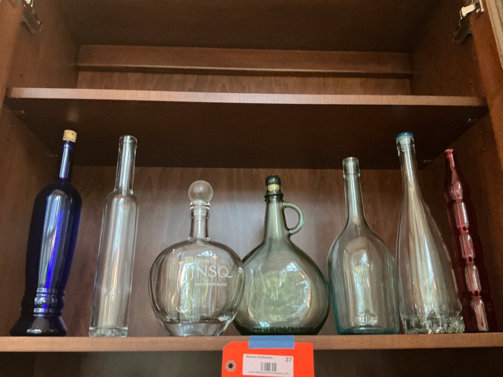 Grouping of assorted decorative glass bottles - Living Room Main Level