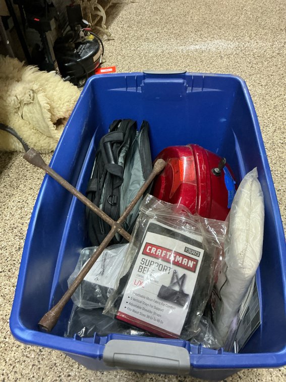 Plastic storage tote with motorcycle top case & contents