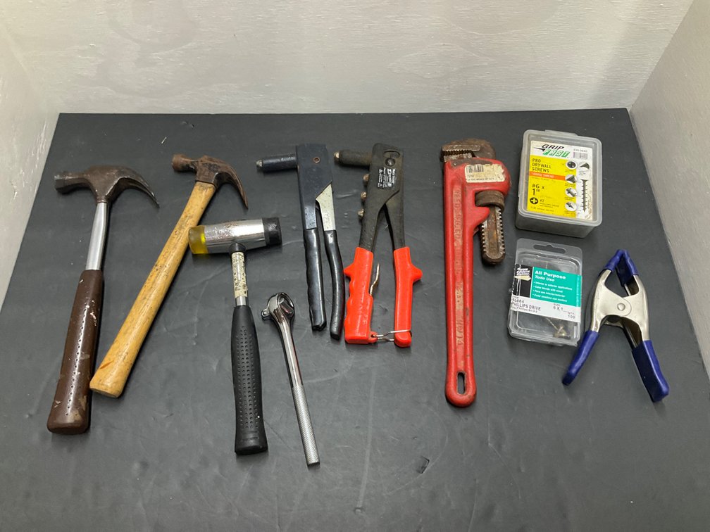 Grouping of hand tools, pipe wrench, hammers & fasteners